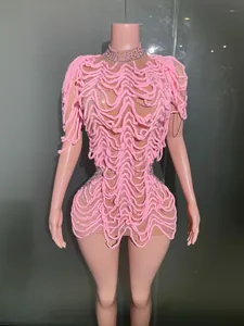 Close-up of pink avant-garde mini dress with wavy texture and rhinestones