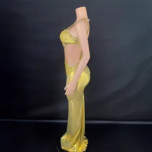 Sleeveless gold evening gown with sexy side cut-outs and glittering rhinestone trim