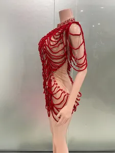 Detailed side view of a red fringed mini dress with silver chains for performances