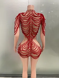 Back detail of a red and nude performance bodysuit with intricate rope design for parties