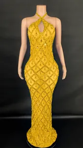 Detail view of golden halter mermaid gown with intricate crystal lattice design