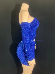 Detailed side view of a shimmering royal blue sequined off-shoulder mini party dress