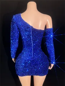 Back view of a sparkling blue one-shoulder sequin mini dress with zipper detail