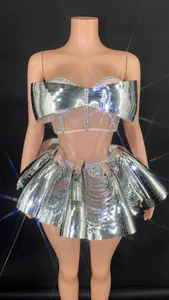 Close-up detail of silver mirror stage outfit with rhinestones for nightclub performance.