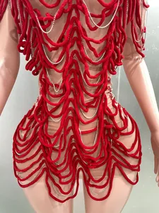 Detailed macro view of red textured wave patterns and silver rhinestone chains