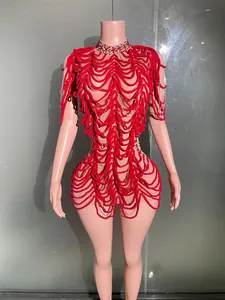 Close-up view of red fringe stage performance dress with silver chain accents