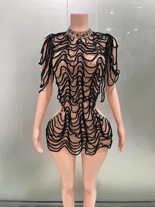 Detailed view of black wavy mesh party dress with bead and chain accents for nightclubs