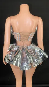 Detailed back view of a silver mirror stage performance costume with rhinestone corset