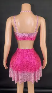 Back view of rose red rhinestone two-piece set with crop top and mini skirt on mannequin.