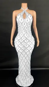 Detailed view of white halter gown with teardrop crystal diamond patterns.