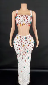 Front view of white two-piece mesh dress decorated with vibrant rhinestone embellishments