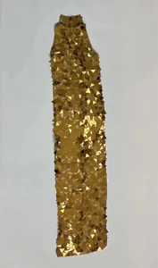 Detail view of a stunning long gold dress with triangular sequin finish for parties.