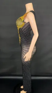 Elegant black slim-fit long dress with gold rhinestones side view for gala or stage performance
