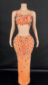 Detail view of orange mesh two-piece dress with vibrant colorful rhinestone grid