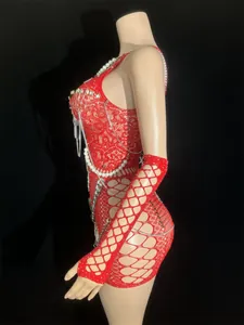Side view detail of red hollow-out mini dress with safety pins and pearl chains