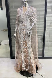Intricate silver rhinestone chain embroidery on transparent mesh cape sleeve gown