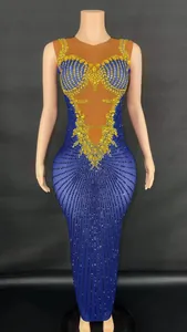 Elegant royal blue evening gown with sparkling gold rhinestones and skin-tone mesh.