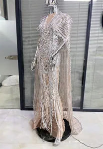 Detailed view of silver sequin patterns on a nude mesh banquet dress with cape sleeves
