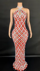 Detailed view of red halter dress with silver grid pattern and teardrop rhinestones.