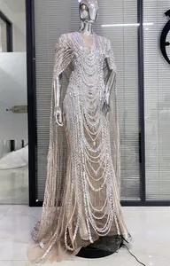 Sheer mesh evening gown with rhinestone tassels and elegant cape sleeves for parties
