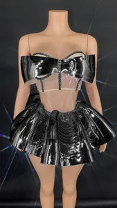 Detailed close-up of a silver mirrored stage performance costume with a pleated skirt