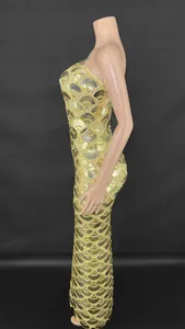 Side view detail of a gold sequined floor-length strapless evening gown