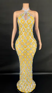 Detailed view of yellow halter neck pageant dress with silver sequins and teardrop diamonds