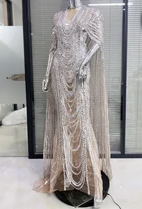 Elegant silver beaded mesh evening gown featuring intricate sequined cape sleeves detail