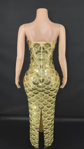 Back view detail of elegant gold sequined strapless evening gown with fish scale pattern