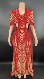 Detail showing the red sequined mesh of this sexy cape-sleeved bodycon banquet dress