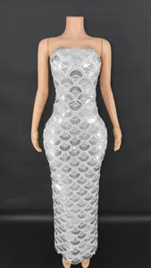Detailed view of a silver heavy sequined strapless mermaid evening gown for elegant parties