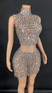 Detailed view of the sparkling rhinestone embellished mesh crop top and mini skirt set.