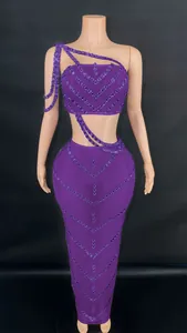 Detailed view of a purple two-piece set with a rhinestone crop top and long skirt