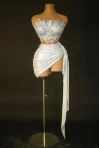 Two-piece fashion set featuring elegant silver sequined crop top and draped mini skirt