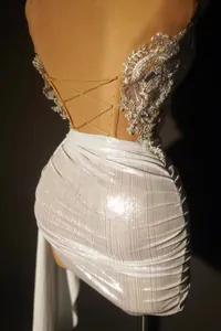 Detailed back view of sequined lace top and ruched metallic mini skirt set