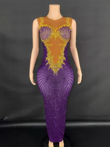Elegant purple floor-length performance dress with gold rhinestones and mesh detailing
