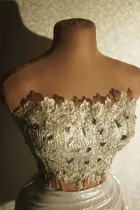Detailed macro view of elegant off-shoulder sequin lace top and pleated mini skirt set