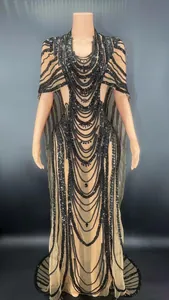 Detailed view of sheer mesh bodycon dress with black sequins and cape sleeve design