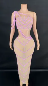 Sexy pink rhinestone two-piece stage set with sheer mesh crop top and long skirt.