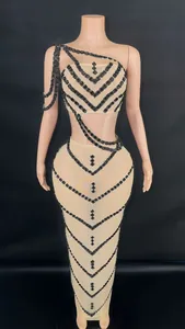 Detail of the intricate black diamond patterns on the mesh crop top and long skirt set.