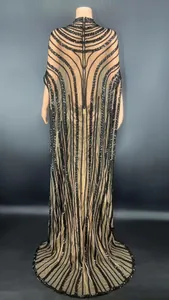 Detailed back view of a sheer mesh gown with sequined patterns and cape sleeves