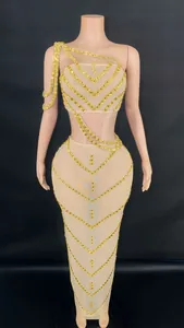 Detailed view of nude mesh two-piece set with gold rhinestones and chain fringe decor