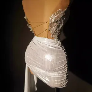 Elegant silver sequined off-the-shoulder top and high-waisted ruched mini skirt set.