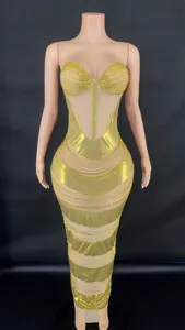 Detailed view of the gold rhinestone embellishments and sheer mesh panels on this bodycon dress