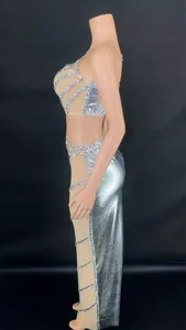 Side view of silver metallic crop top and side rhinestone long skirt set on mannequin