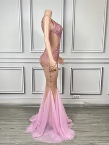 Side view of pink rhinestone mermaid gown with sheer mesh for stage performance