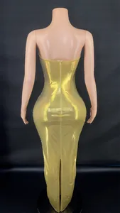 Detailed rear view showing the shiny metallic gold backless bodycon maxi evening dress