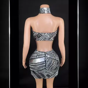 Sexy silver rhinestone two-piece set featuring backless crop top and mini skirt on mannequin