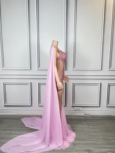Side view of an elegant pink sequin fishtail performance dress with a long chiffon cape train