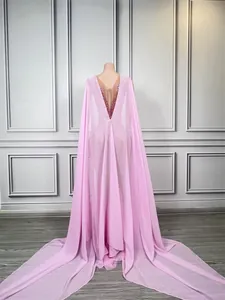Elegant pink mermaid evening gown with deep V-back and dramatic chiffon trailing cape